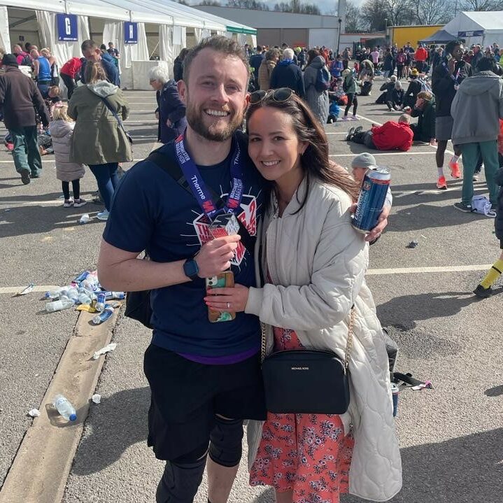Image of Josh with partner after completing marathon for Crohn's and Colitis