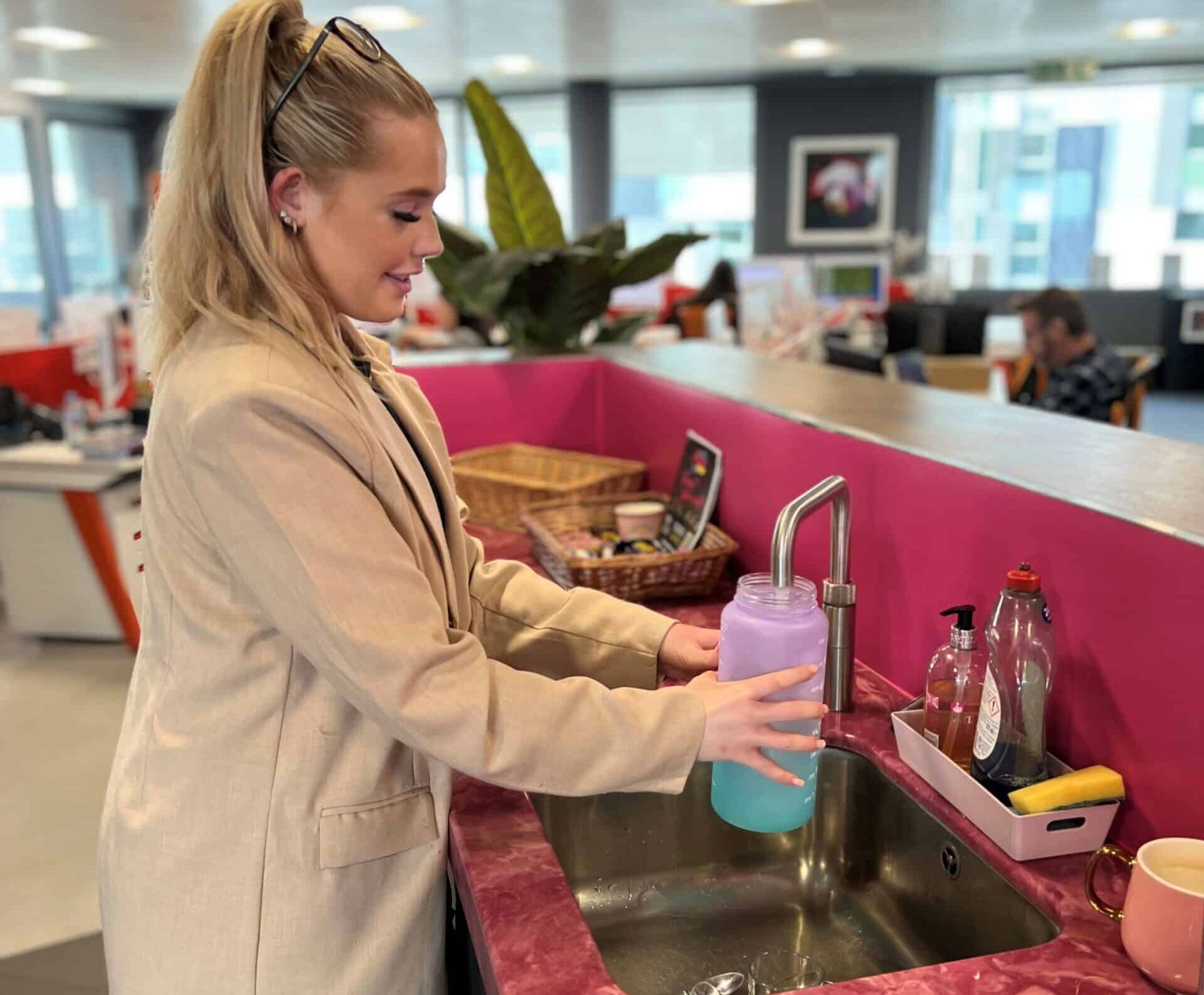 Paralegal, Beth filling up her water bottle in the sink